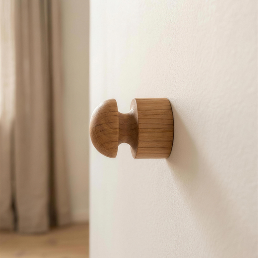 Close-up side view of Anchor solid oak wall hook showing deep groove and wide head
