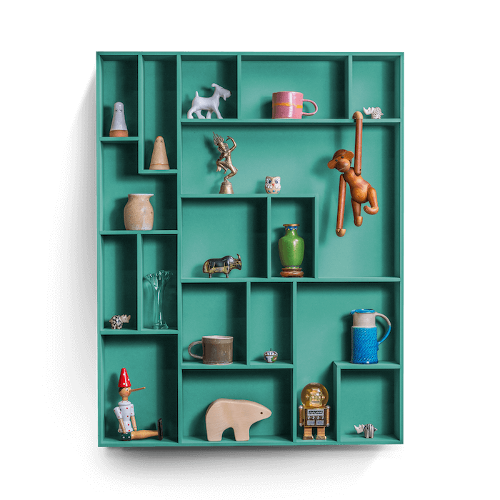 decorative wall shelf with colorful compartments displaying various treasures