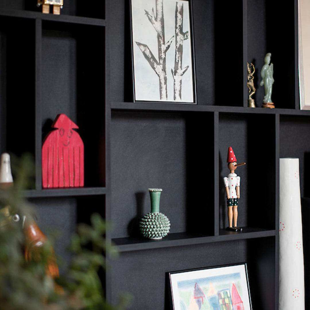 Close-up of NicNac Timeless Box Shelf in black, compartment detail with small art and collectibles.