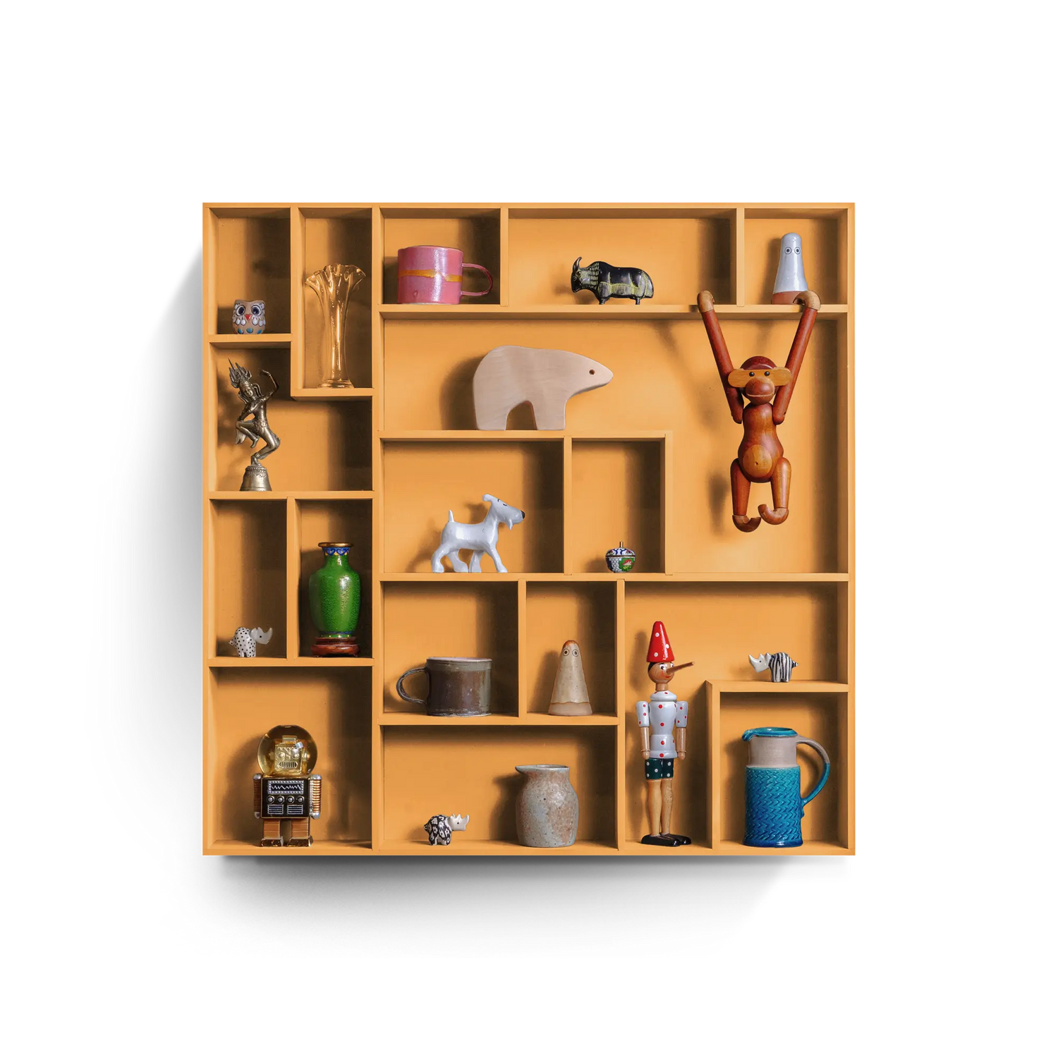 Compact orange decorative wall shelf with playful grid compartments displaying various small decorative items and figurines