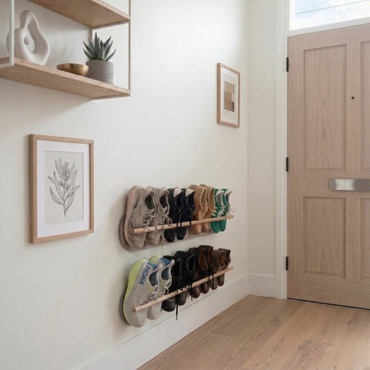 Two khaki Grounded wall-mounted floating shoe racks in a minimalist Copenhagen hallway