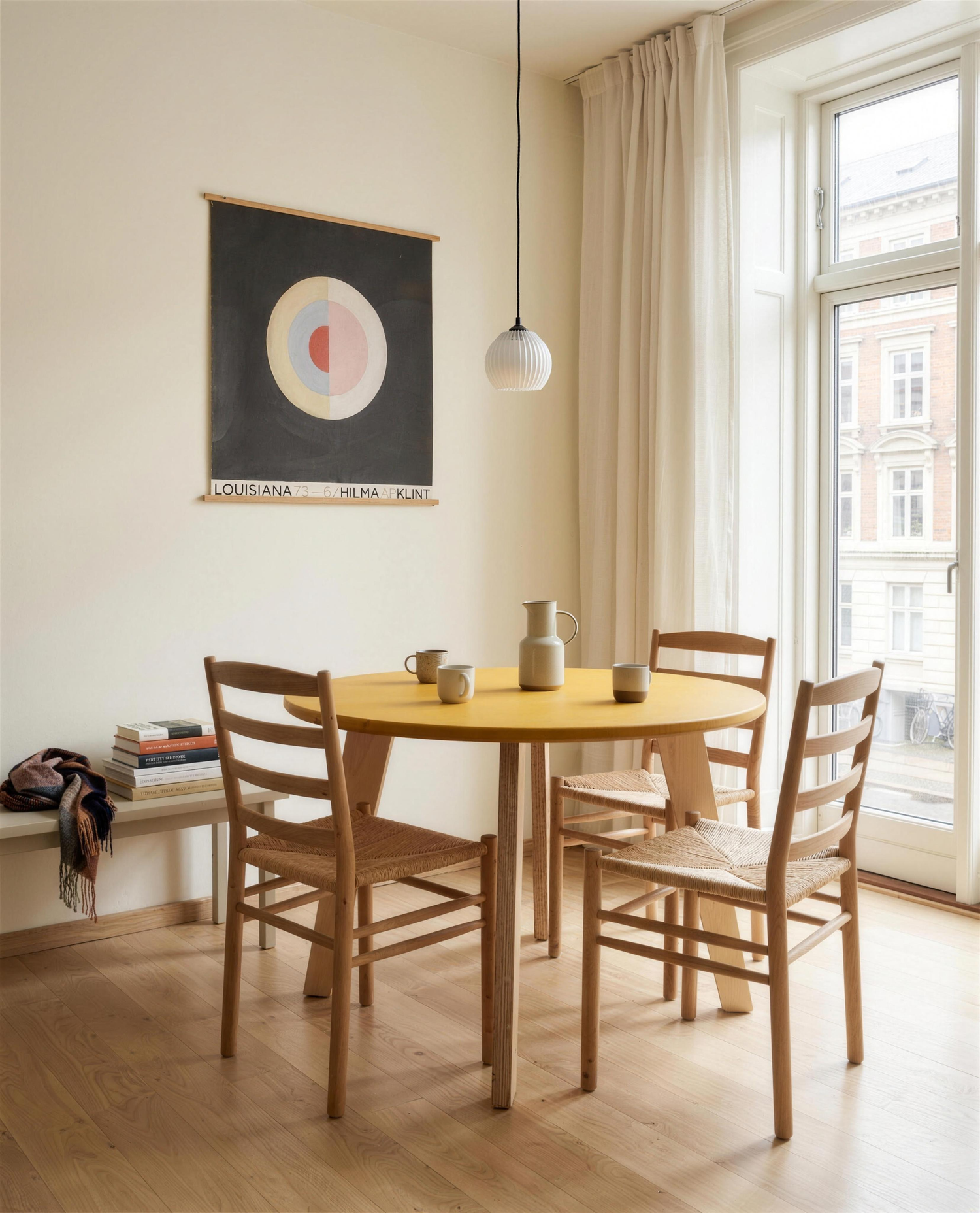 Bjørk round dining table in yellow Valchromat® with birch plywood legs in a Copenhagen dining nook