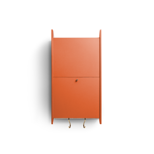 Space-saving cabinet with upward-gliding doors and removable dowel in orange Valchromat®.