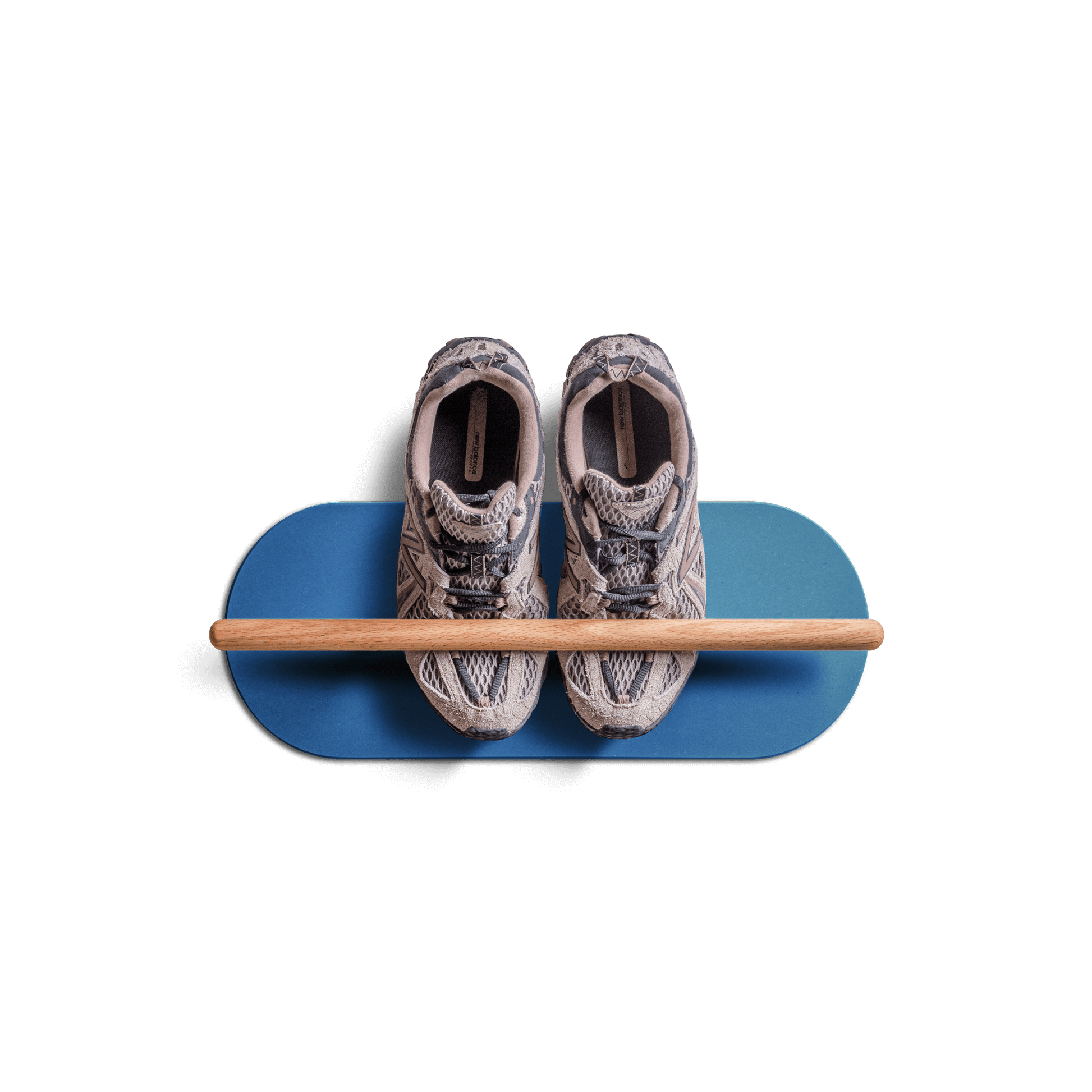 Minimalist space saving shoe rack in blue with wooden bar holding a pair of sneakers