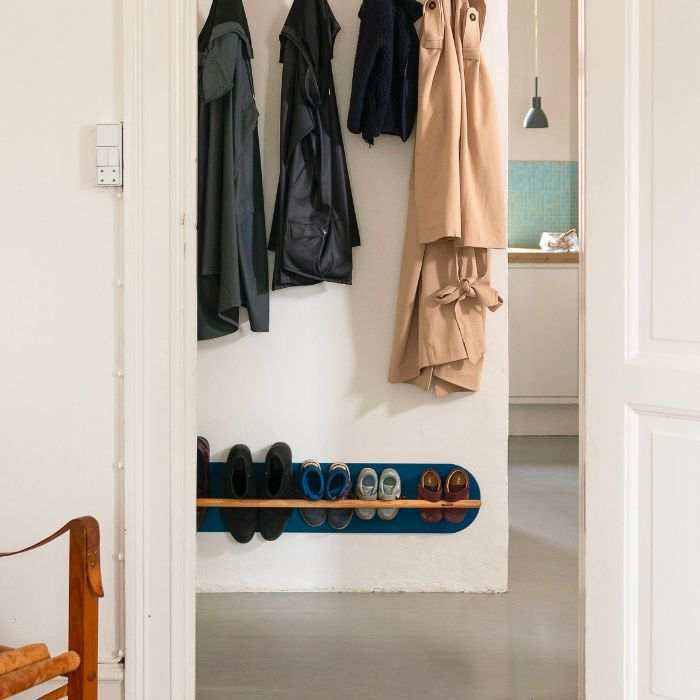 Minimalist space saving shoe rack in hallway, designed for small apartments and modern homes.