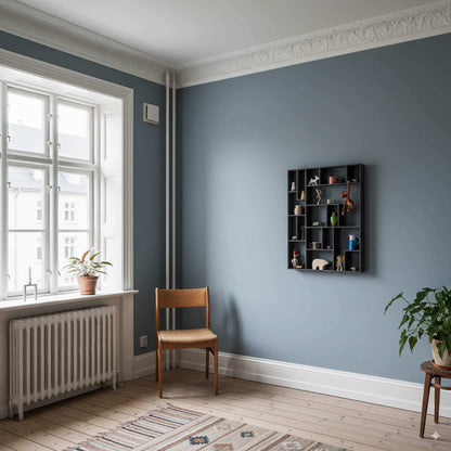 NicNac Tall – Timeless Box Shelf in Black Valchromat, on a blue wall in a classic Copenhagen apartment.