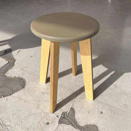 Bjørk Large wooden stool with blue Valchromat seat and natural wood legs on concrete floor
