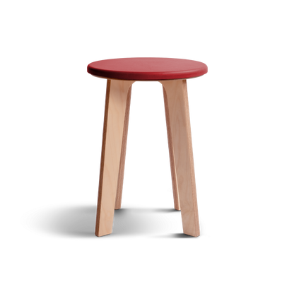 Birch stool with vibrant red Valchromat® top and minimalist birch plywood legs.