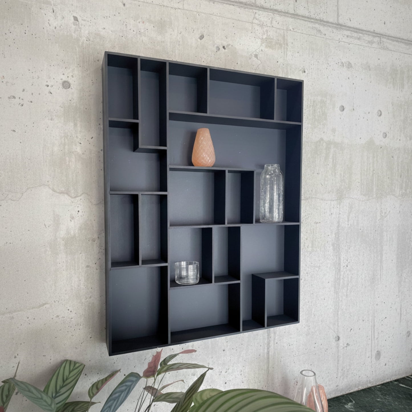 NicNac Tall - Timeless Box Shelf in black valcromat against a concrete wall.