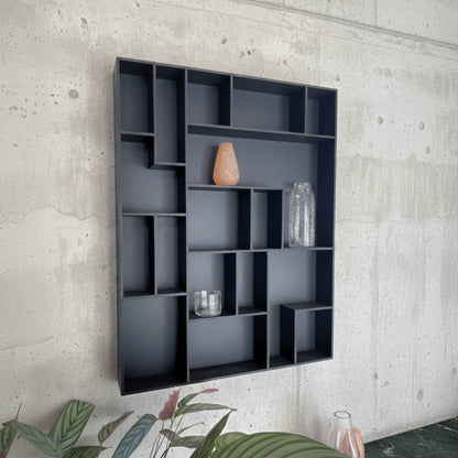 NicNac Tall - Timeless Box Shelf in black valcromat against a concrete wall.