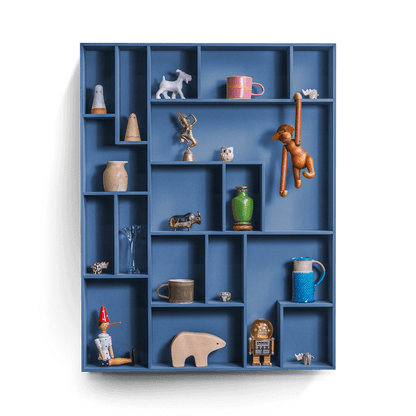 Decorative wall shelf with playful compartments displaying various items.