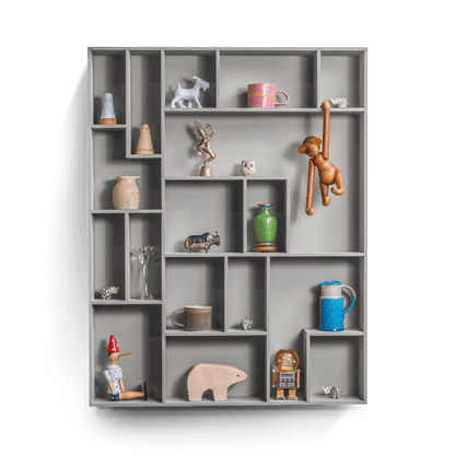 Decorative wall shelf with playful compartments and various displayed items.