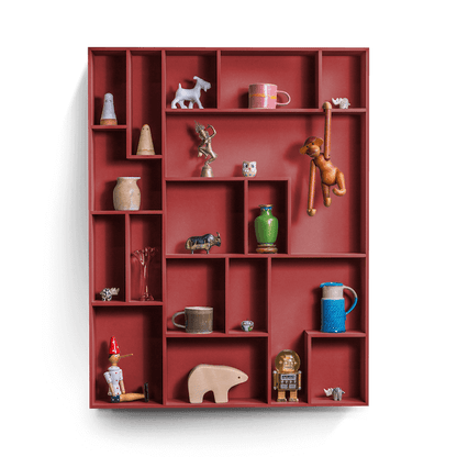 Decorative wall shelf with playful compartments displaying various items.