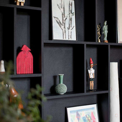 Close-up of NicNac Timeless Box Shelf in black, compartment detail with small art and collectibles.