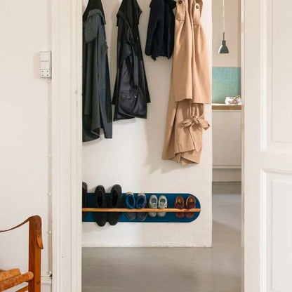 Minimalist space saving shoe rack in hallway, designed for small apartments and modern homes.