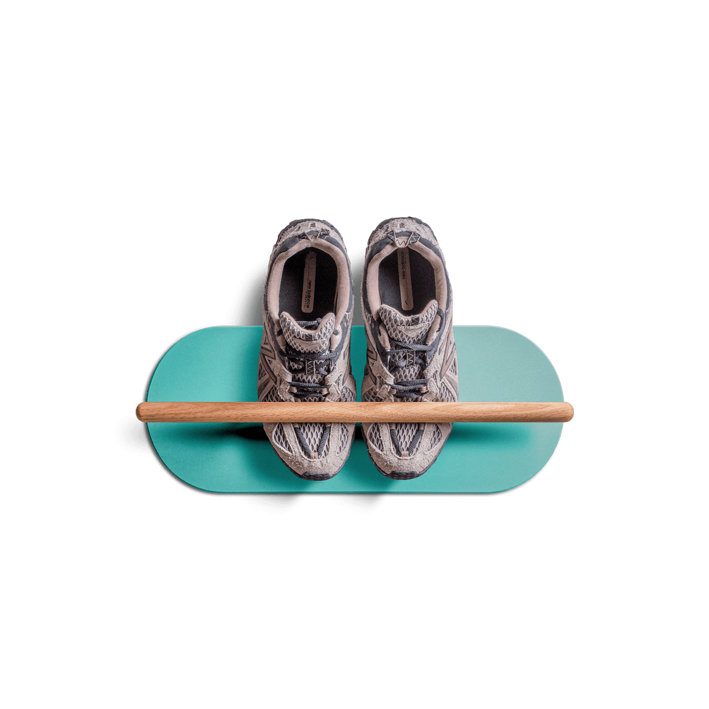 Minimalist space saving shoe rack with floating design holding a pair of sneakers on teal base with wooden rod.