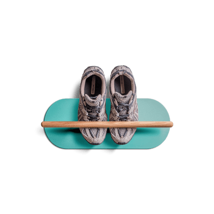 Minimalist space saving shoe rack with floating design holding a pair of sneakers on teal base with wooden rod.