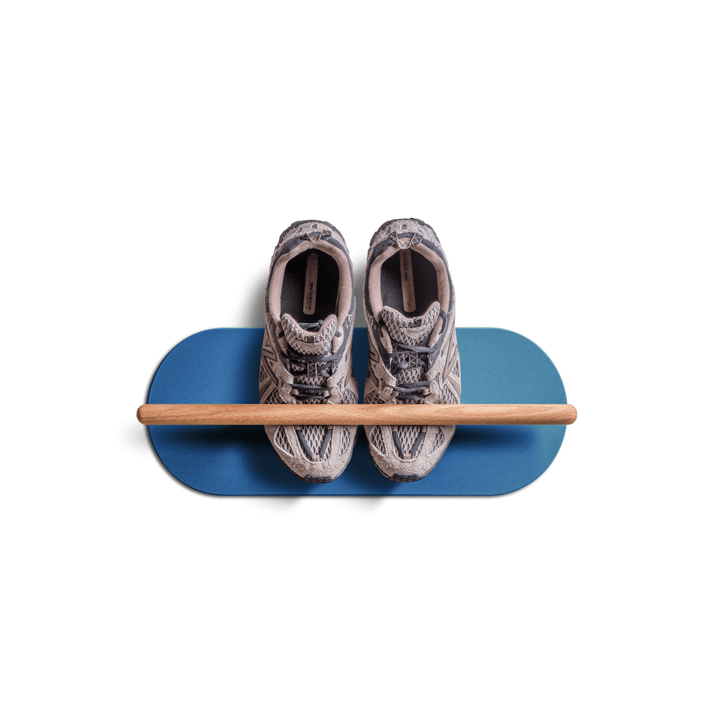 Minimalist space saving shoe rack in blue with wooden bar holding a pair of sneakers