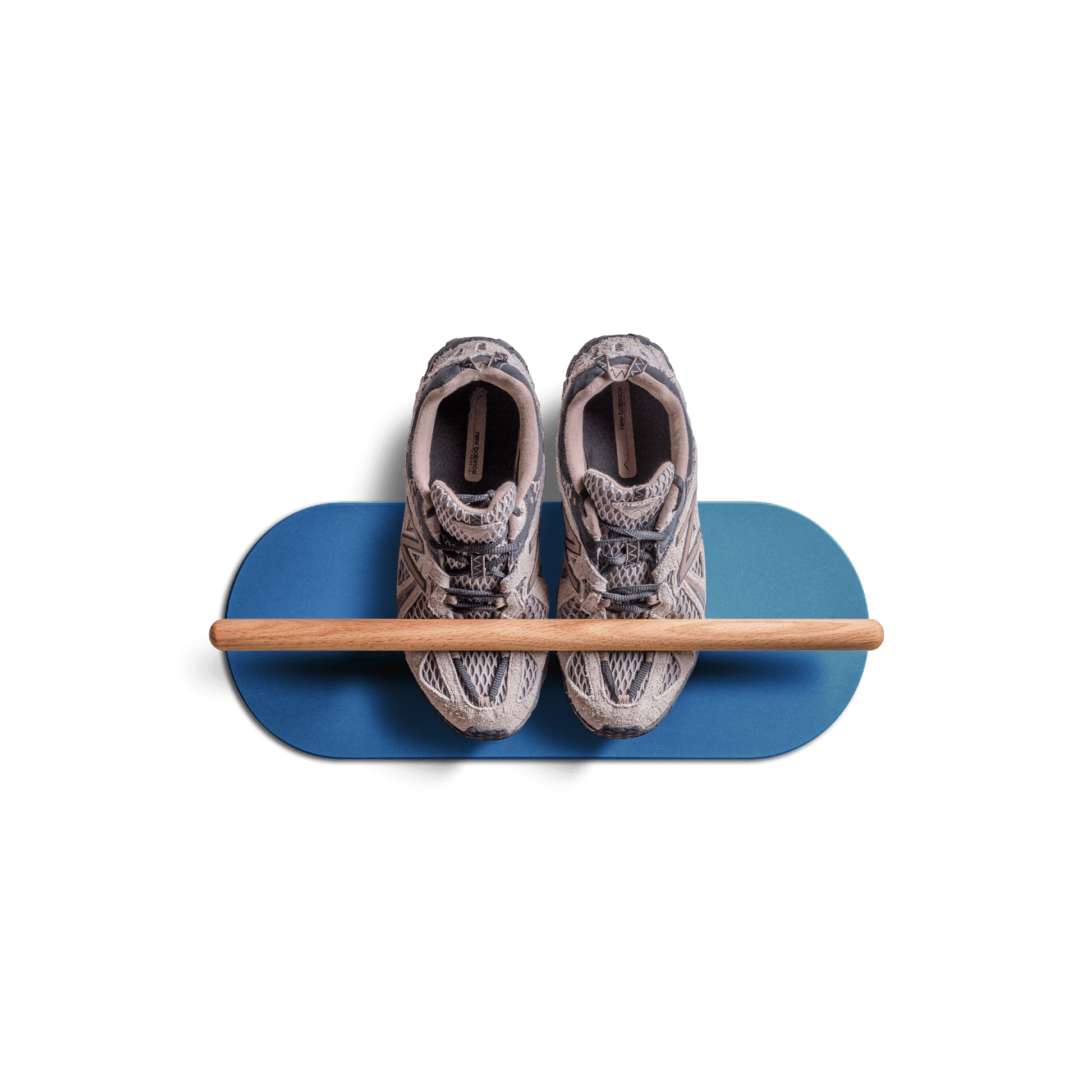 Minimalist space saving shoe rack in blue with wooden bar holding a pair of sneakers