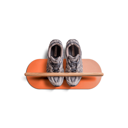 minimalist space saving shoe rack with floating wooden bar holding shoes on orange base