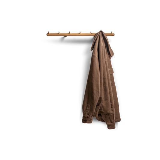 Adapt coat rack, wall mounted in oak with brass hooks, front view with jacket hanging