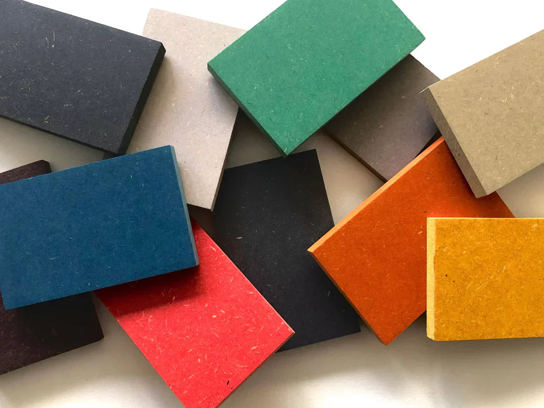 Stacked Valchromat® boards in many colours showing the coloured edges and matte fibre surface