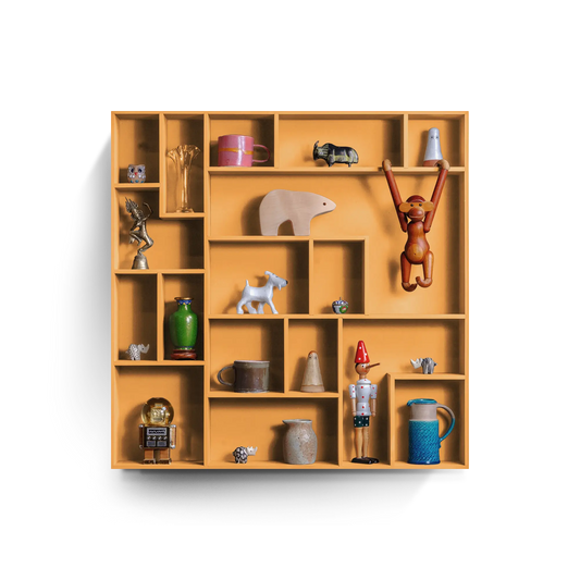 Compact orange decorative wall shelf with playful grid compartments displaying various small decorative items and figurines
